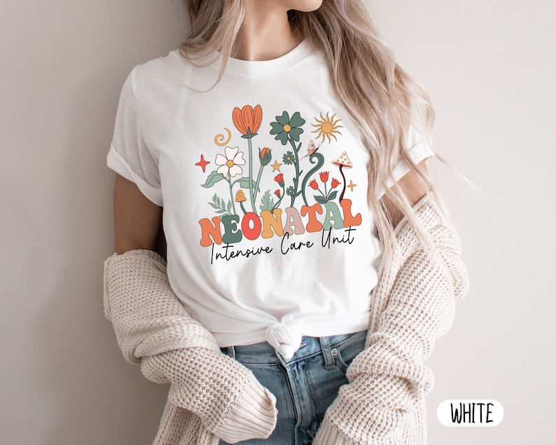 May include: White t-shirt with a floral design and the text "Neonatal Intensive Care Unit".
