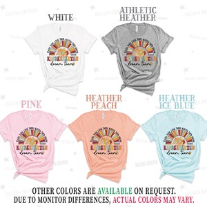 May include: Five different color t-shirts with a rainbow and flower design. The text on the shirts reads "Teach them, love them, watch them grow. Kindergarten dream team."