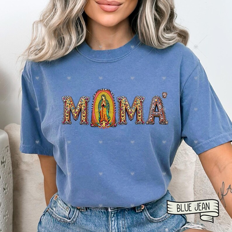 May include: A blue t-shirt with the word "MOMA" spelled out in colorful letters with a depiction of the Virgin Mary in the center of the word.