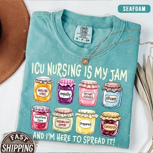 May include: A teal blue t-shirt with the text "ICU NURSING IS MY JAM" and a row of colorful jars with words like "Healing Vibes", "Empathy", "Patient Focused", "Efficient", "Excellent Care", "Personalized Support", "Prepared", and "Compassion". The text "AND I'M HERE TO SPREAD IT!" is below the jars.