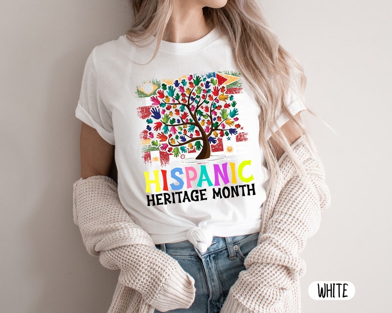 May include: White t-shirt with a colorful tree made of handprints and the text "Hispanic Heritage Month".