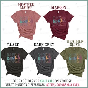 May include: Five t-shirts in different colors with the word "Doula" repeated three times in a retro font. The colors are heather mauve, maroon, black, dark grey, and heather olive.