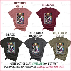 May include: A collection of t-shirts featuring a skeleton and unicorn design with the text "The Audacity". The shirts are available in heather mauve, maroon, black, dark grey heather, and heather olive.