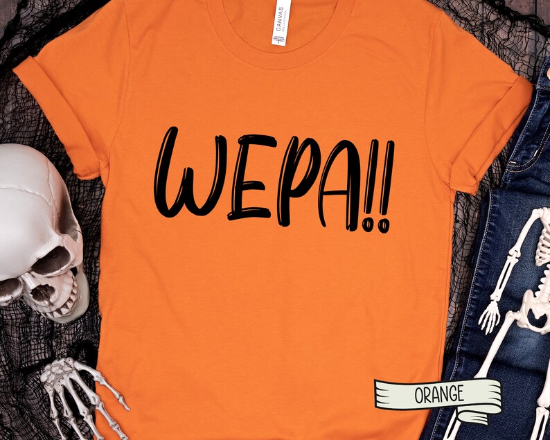 May include: Orange t-shirt with the text "WEPA!!" in black lettering.