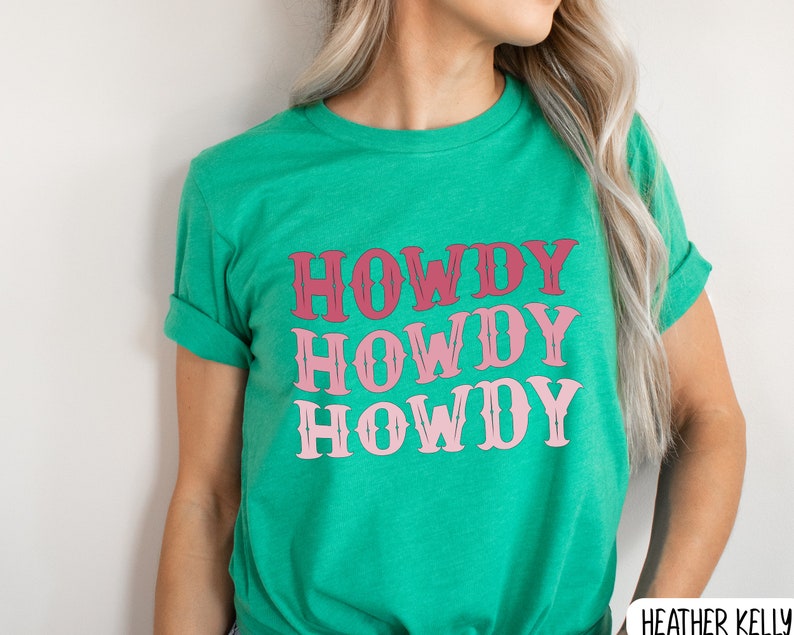 May include: A green t-shirt with the text "Howdy Howdy Howdy" in pink and red lettering.