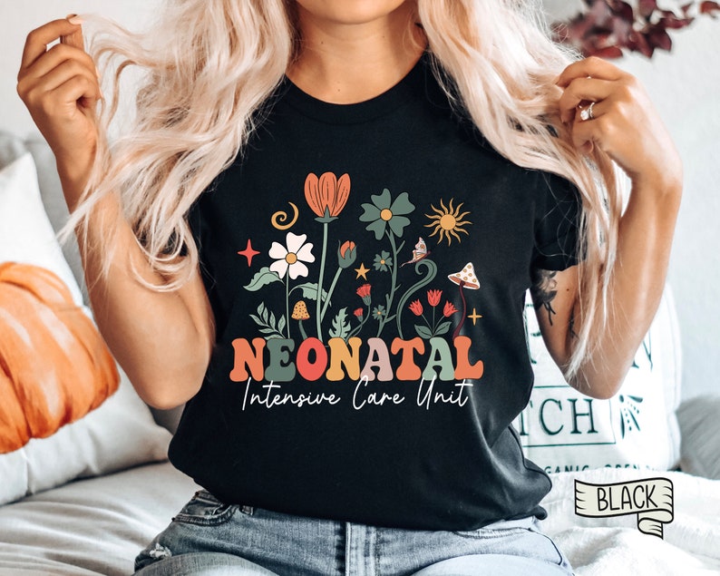May include: Black t-shirt with a floral design and the text "Neonatal Intensive Care Unit" in colorful letters.