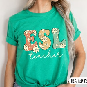 May include: Green t-shirt with the text "ESL teacher" in colorful letters with a floral pattern.