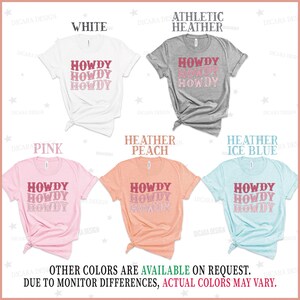 May include: Five t-shirts in different colors with the text "Howdy" repeated three times in a gradient of pink and red. The colors of the t-shirts are white, athletic heather, pink, heather peach, and heather ice blue.