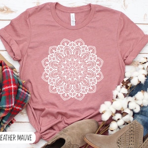 May include: Heather mauve t-shirt with a white mandala design.