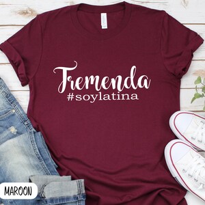 May include: Maroon t-shirt with white text that reads "Tremenda #soylatina".