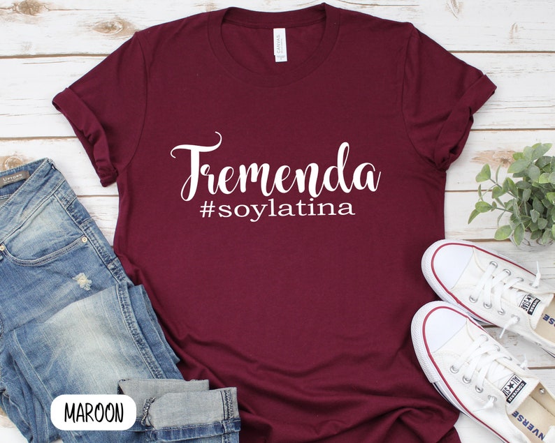 May include: Maroon t-shirt with white text that reads "Tremenda #soylatina".