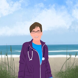 May include: A woman wearing a purple medical scrubs jacket with a stethoscope around her neck. She is standing on a sandy beach with tall grass and blue water in the background.