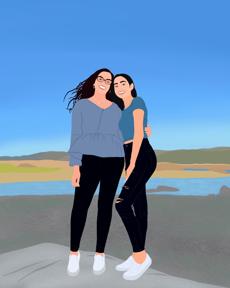 May include: Two women are standing together, smiling at the camera. They are both wearing casual clothing, including jeans and t-shirts. The woman on the left is wearing a blue shirt and the woman on the right is wearing a light blue shirt. They are standing in front of a body of water and a grassy area.