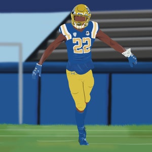 May include: A football player wearing a blue and gold uniform with the number 22 on the front. The player is wearing a helmet and gloves. The player is standing on a green field with a blue fence in the background.