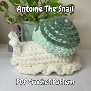 May include: Crochet pattern for Antoine the Snail, a plush toy with a white body and a green and white shell. The pattern is available as a PDF download.