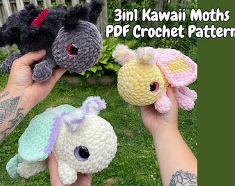 May include: Three crocheted moth plushies in different colors. A black moth with red accents, a yellow moth with pink accents, and a white moth with green and purple accents. The plushies are all holding in hands. The image text reads "3in1 Kawaii Moths PDF Crochet Pattern".