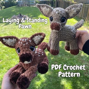 May include: Two plush fawn toys made of soft yarn, one dark brown and one light tan, both featuring large black eyes, white spots, and pointed ears. The text Laying & Standing Fawn and PDF Crochet Pattern is visible on the image.