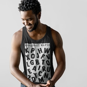 May include: Black tank top with the text "ALPHABET MAFIA" and a jumbled arrangement of letters. The tank top is worn by a person in blue jeans. The background is a plain white.