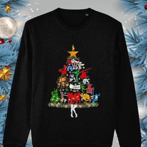 May include: Black long-sleeve sweatshirt with a Christmas tree design featuring various musical characters and the name "Connor" at the bottom.