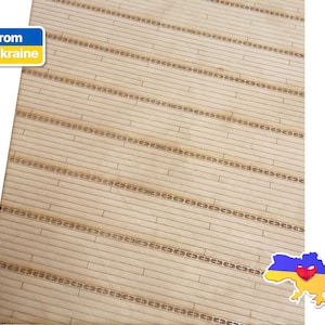May include: A close-up of a light brown wooden surface with a repeating pattern of small brown squares. The surface is textured and has a slight sheen. The image is labeled "From Ukraine" in the top left corner and features a yellow and blue outline of Ukraine with a red heart in the bottom right corner.