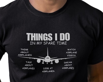May include: Black t-shirt with white text and a graphic of an airplane. The text reads "THINGS I DO IN MY SPARE TIME" with related phrases like "Think about airplanes" and "Watch airplane videos."