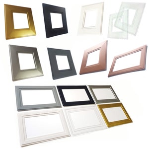 May include: A selection of square picture frames in colours such as gold, black, white, grey, and bronze. The frames have a beveled edge and a square aperture for the picture. Measurements are in cm.