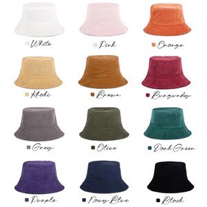 May include: A collection of bucket hats in various colors, including white, pink, orange, khaki, brown, burgundy, grey, olive, dark green, purple, navy blue, and black. Each hat is displayed with its corresponding color name.
