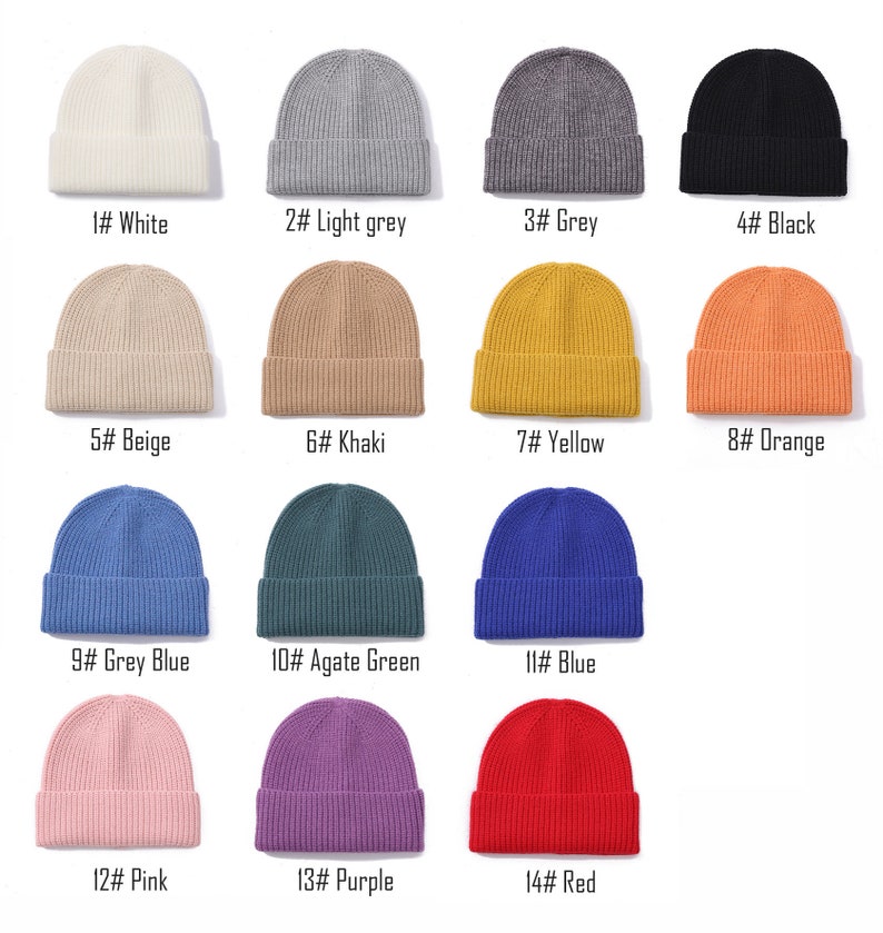 May include: A set of 14 knit beanies in various colors, including white, light grey, grey, black, beige, khaki, yellow, orange, grey blue, agate green, blue, pink, purple, and red. Each beanie has a ribbed texture.