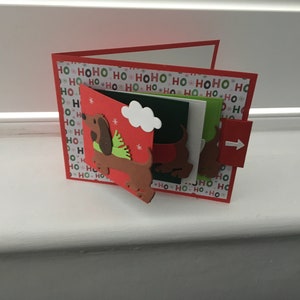 Um cartão de cachoeira de Natal de Dachshund feito à mão