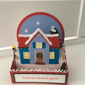 Biglietto pop-up fatto a mano con scena invernale della casa di Natale