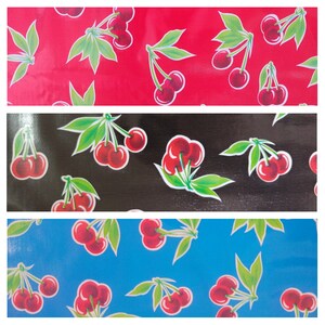 May include: Three fabric swatches with a repeating pattern of red cherries on a red background, black cherries on a black background, and blue cherries on a blue background.