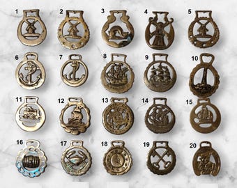 May include: Twenty brass horse brasses with various designs, including windmills, ships, anchors, lighthouses, and a train. The brasses are numbered 1 through 20.