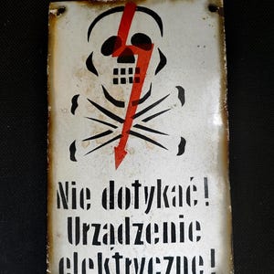 Vintage industrial metal warning sign.