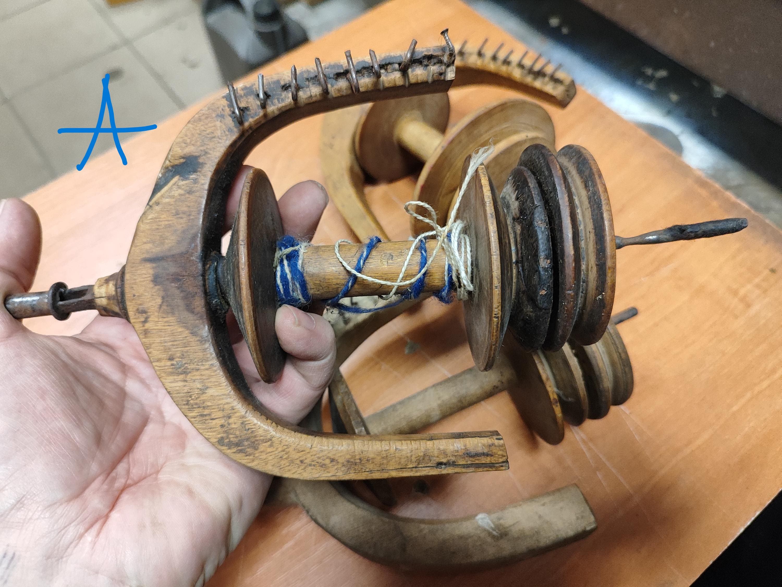 Part of the antique wood spinning wheel.