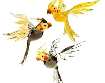 Cockatiels flying from glass