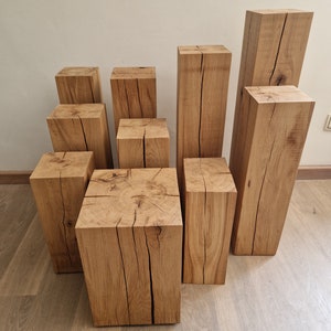 May include: A set of nine wooden blocks of varying sizes, stacked in a staggered formation. The blocks are made of natural wood with a light brown color and have a rough, rustic texture. The blocks are perfect for creating a unique and modern display in your home.