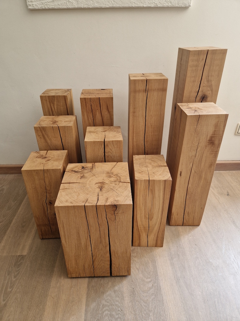 May include: A set of nine wooden blocks of varying sizes, stacked in a staggered formation. The blocks are made of natural wood with a light brown color and have a rough, rustic texture. The blocks are perfect for creating a unique and modern display in your home.