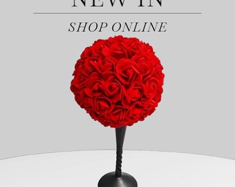 May include: A red rose ball centerpiece on a black metal stand.  The ball is made of many small red roses.  NEW IN SHOP ONLINE.