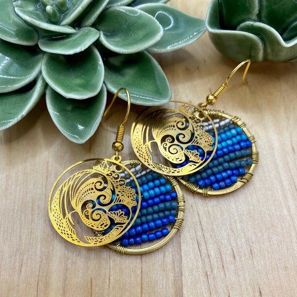 Round golden earrings with delicate ornament with whale, and waves. Sea earrings with blue glass beads. Moby Dick earrings.