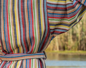 May include: A striped robe with a sash tie. The robe is made of a soft, lightweight fabric and features a variety of colors, including red, blue, yellow, and brown.