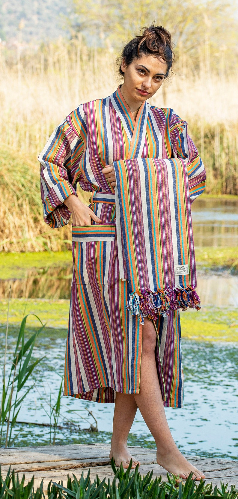 May include: A striped robe with a matching striped towel. The robe has a sash and pockets. The towel has fringe on the bottom.