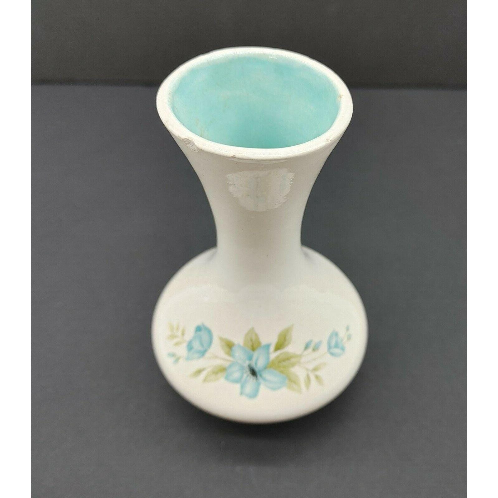 青い花柄とターコイズ色の内側が入った陶器の花瓶。Anna 1972 VTG の 