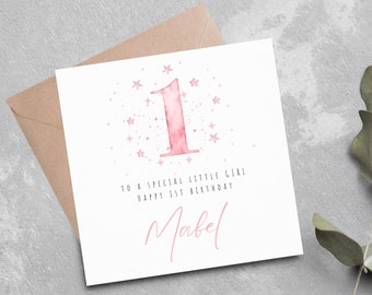 Op de afbeelding: Roze aquarel verjaardagskaart met een groot nummer één en roze sterren. De kaart zegt "To a special little girl, Happy 1st Birthday Mabel".