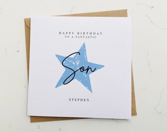 Può includere: Un biglietto bianco con una stella blu e il testo "Happy Birthday to a Fantastic Son Stephen".