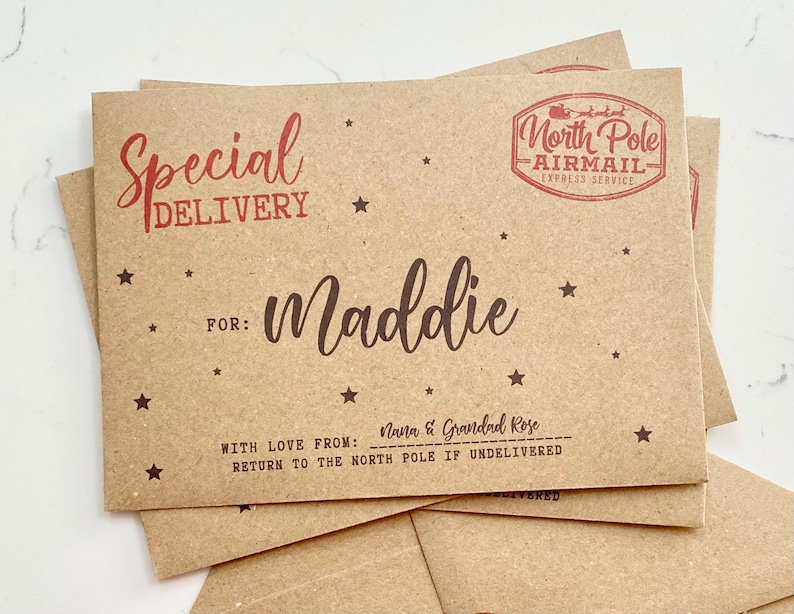 May include: A brown paper envelope with a red "Special Delivery" stamp and a red "North Pole Airmail" stamp. The envelope is addressed to "Maddie" with the message "With love from: Nana & Grandad Rose" and "Return to the North Pole if undelivered".