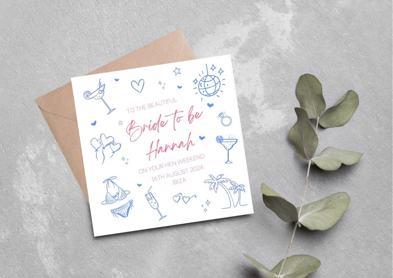 May include: A white card with blue and pink illustrations of a cocktail glass, a bikini, a palm tree, a disco ball, and hearts. The text on the card reads "To the beautiful Bride to be Hannah On your hen weekend 16th August 2024 Ibiza."