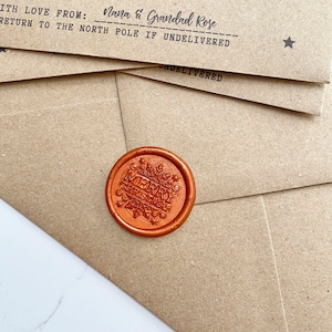 May include: A brown paper envelope with a red wax seal that says "Merry Christmas". The envelope has the text "With love from: Nana & Grandad Rose" and "Return to the North Pole if undelivered".
