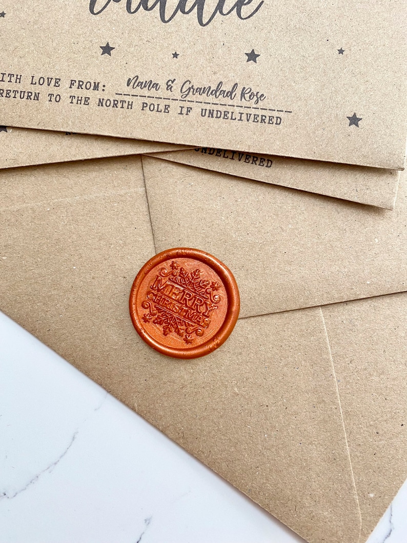 May include: A brown paper envelope with a red wax seal that says "Merry Christmas". The envelope has the text "With love from: Nana & Grandad Rose" and "Return to the North Pole if undelivered".