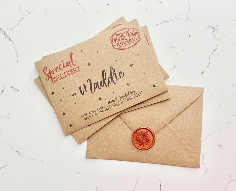 May include: A brown paper envelope with a red wax seal and a handwritten note that says "Special Delivery" for "Maddie" with a red star design. The note says "With love from:  Santa & Granded Elves. Return to the North Pole if undelivered."