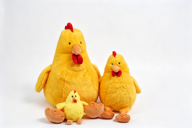 May include: Three plush chicken toys in varying sizes, all featuring bright yellow soft fabric, red combs and wattles, and orange beaks. The set includes one large chicken, one medium chicken, and one small chick, all sitting upright on a plain surface.